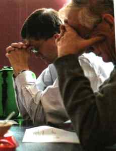 Rob Quiring and retired AAI teacher Chuck Howard praying.